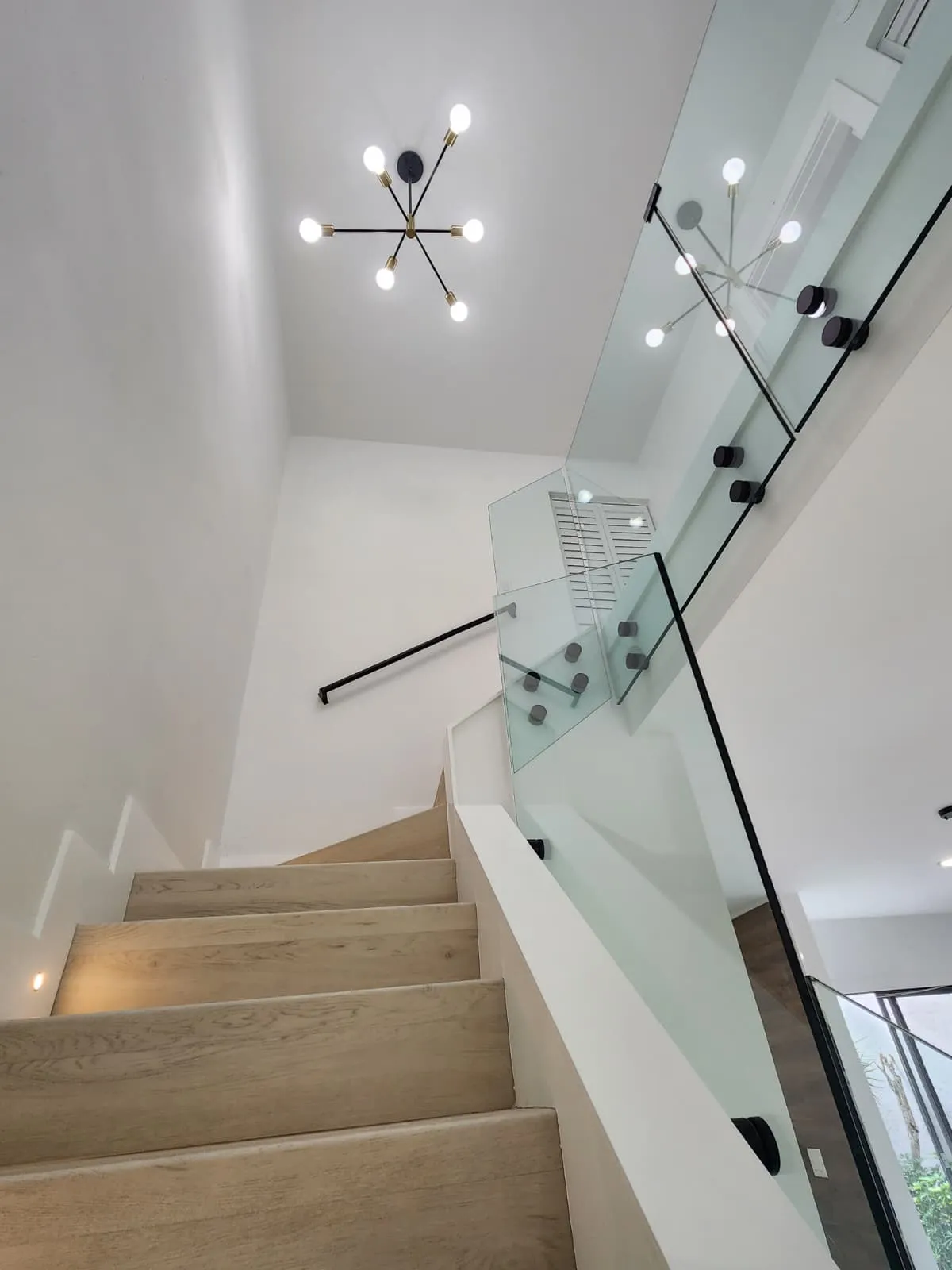 Wood-look flooring and staircase with glass railing