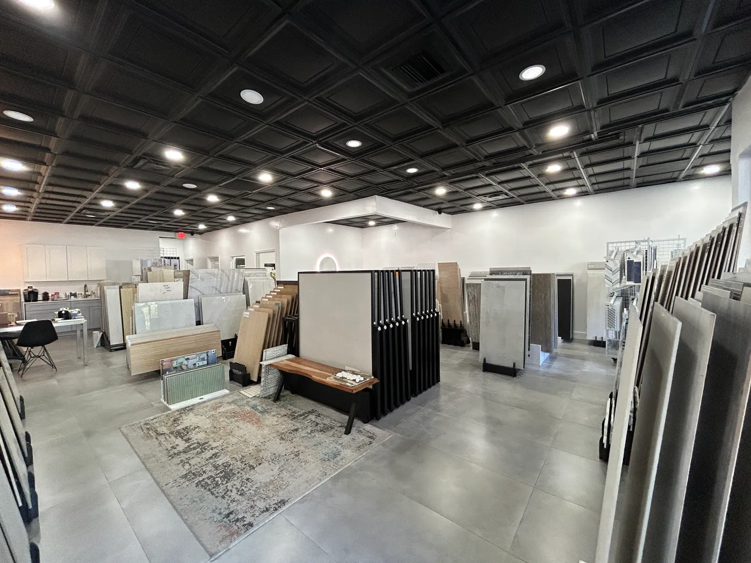 Large-format porcelain and stone slabs displayed floor to ceiling