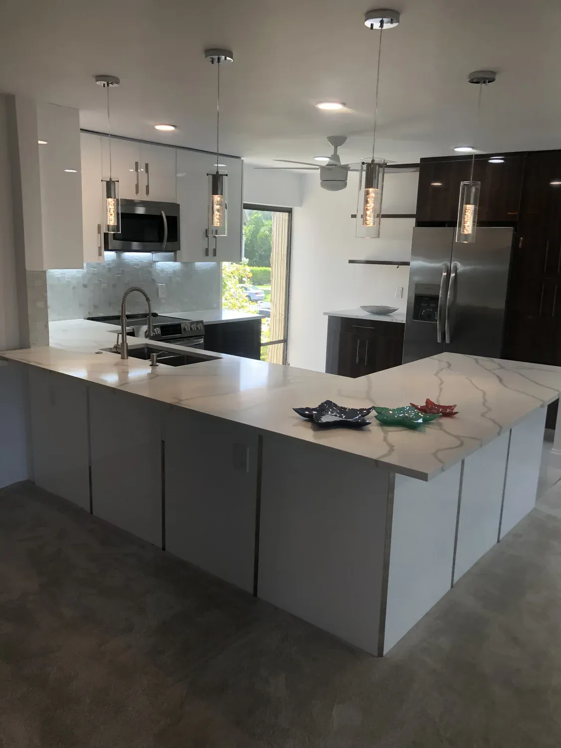 Kitchen with dark wood cabinetry and glass pendant lighting