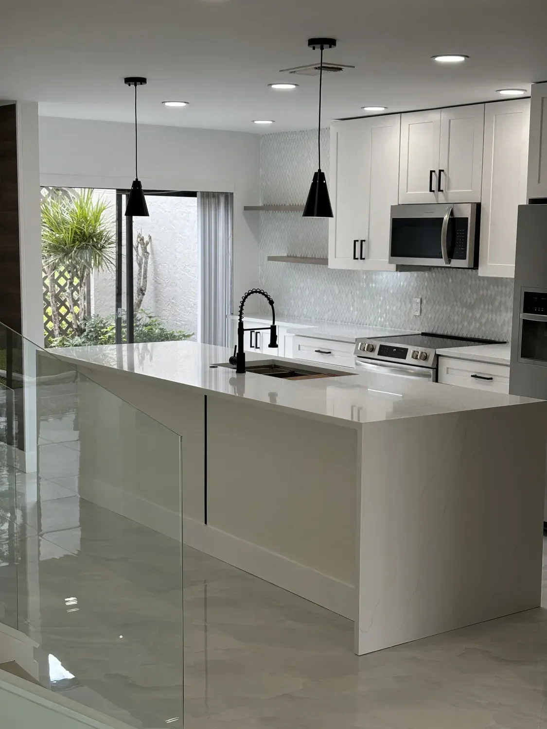 Modern Kitchen with Glass Stair Railing