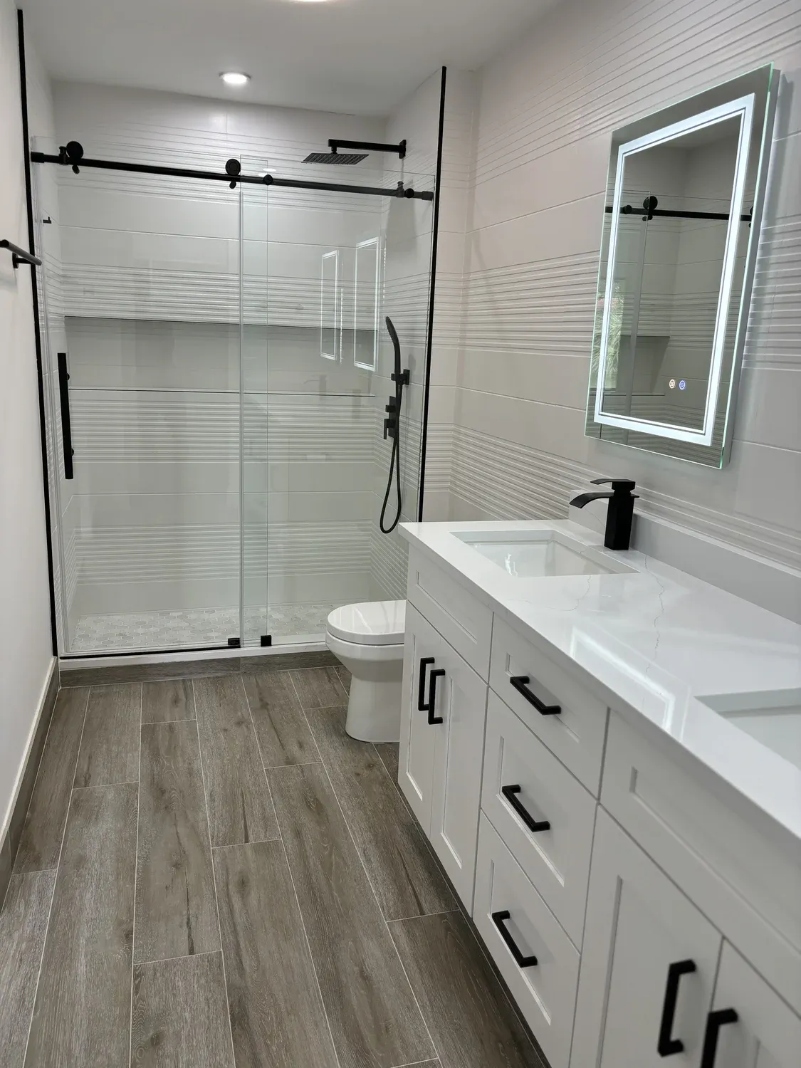 White Bath with Wood-Look Flooring