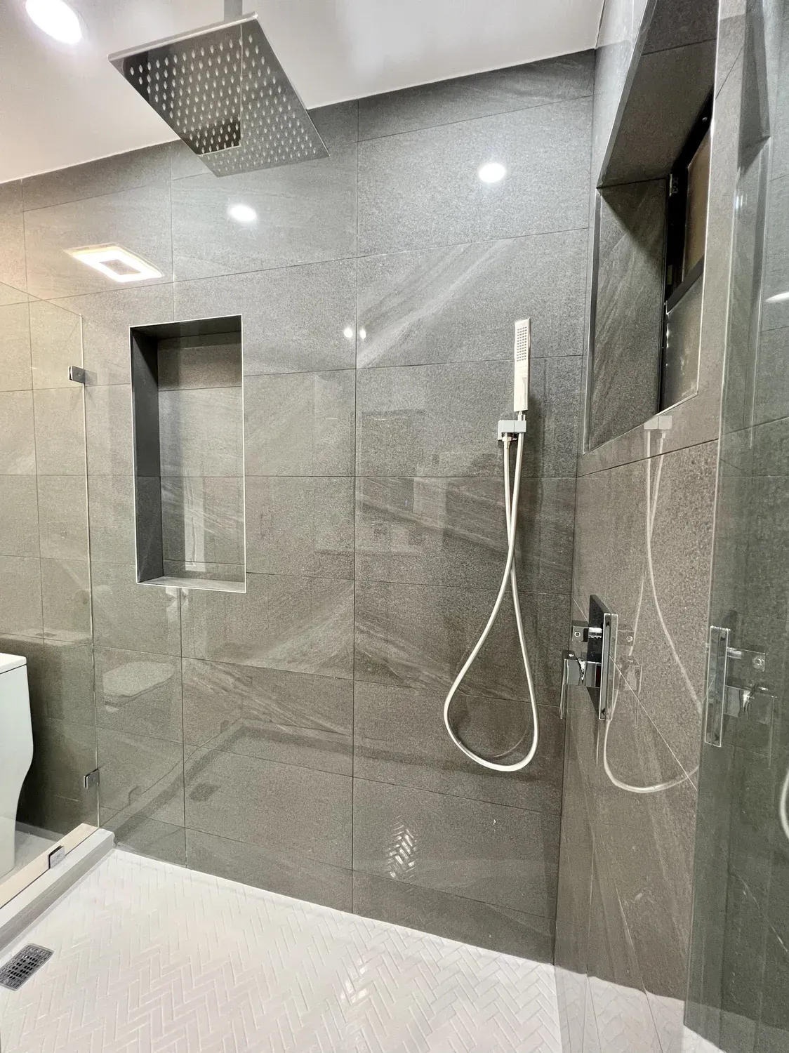 Dark Tile Shower with White Closet Wall